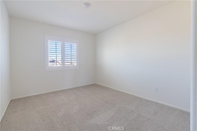 unfurnished room with baseboards and carpet floors