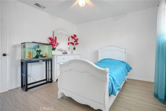 bedroom featuring visible vents, ceiling fan, light wood-style flooring, and baseboards