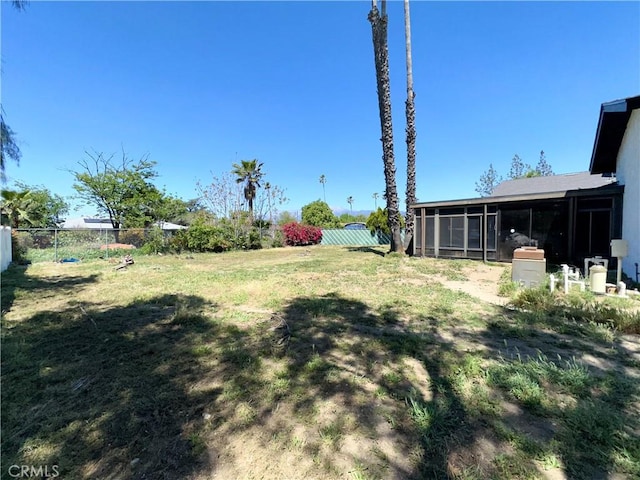 view of yard featuring a fenced backyard and a sunroom