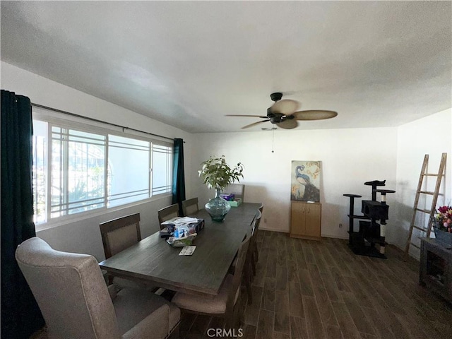 dining area featuring baseboards, wood finished floors, and a ceiling fan