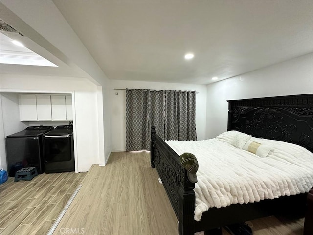 bedroom with recessed lighting, independent washer and dryer, light wood-style floors, baseboards, and visible vents