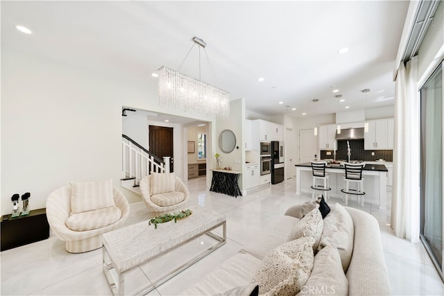 living area featuring stairway and recessed lighting