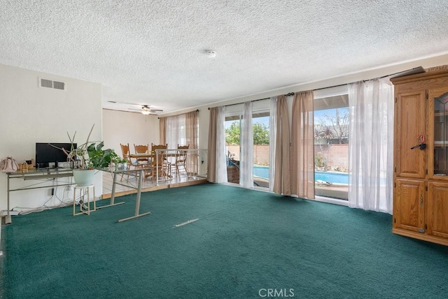 miscellaneous room featuring visible vents, a textured ceiling, and carpet floors