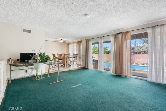 interior space with visible vents, a textured ceiling, and carpet floors