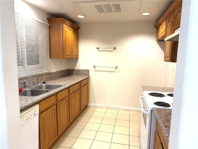 kitchen featuring white appliances, light tile patterned floors, visible vents, a sink, and recessed lighting