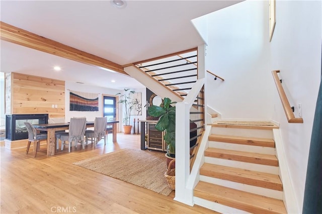 staircase featuring wood finished floors and recessed lighting