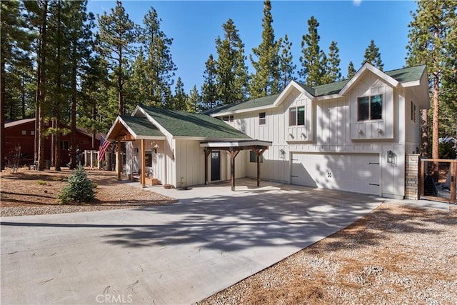 view of front of house with a garage, driveway, and board and batten siding