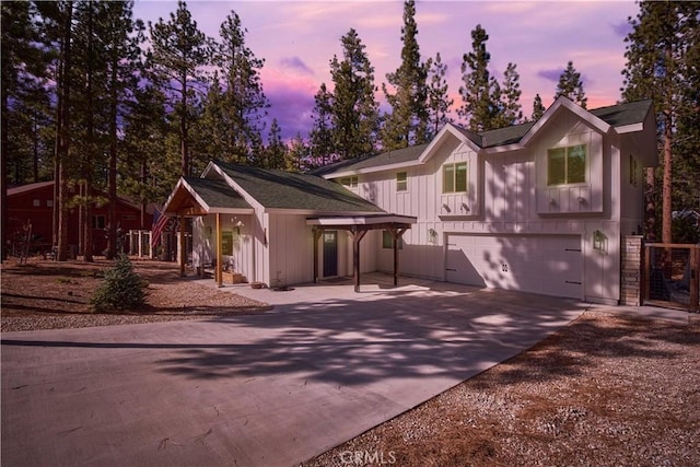 view of front of house featuring concrete driveway, board and batten siding, and an attached garage