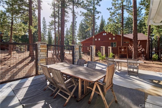 view of patio featuring outdoor dining area and fence