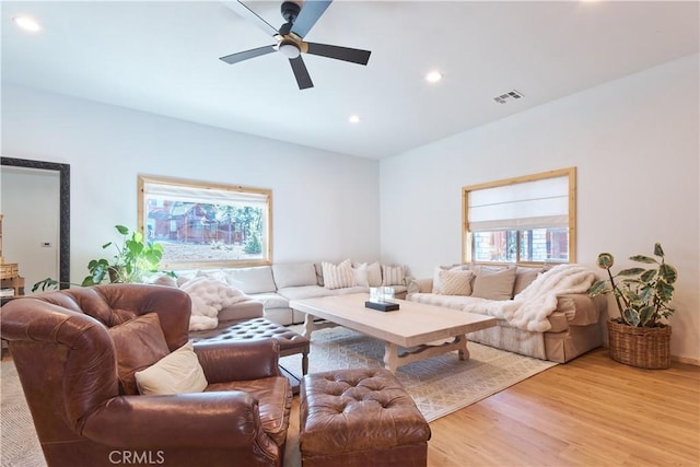 living room with a ceiling fan, recessed lighting, visible vents, and wood finished floors