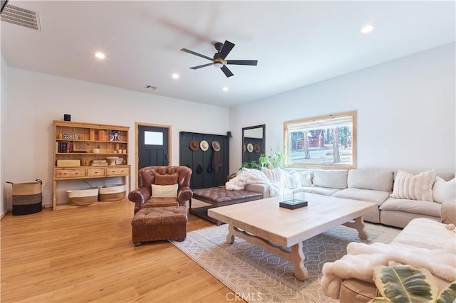 living room featuring a ceiling fan, recessed lighting, visible vents, and light wood-style floors