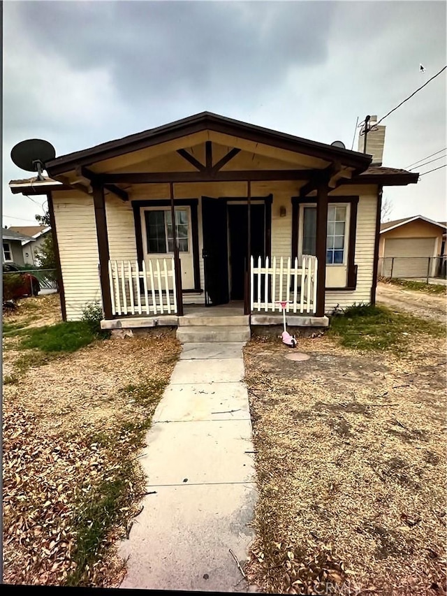 view of front of home featuring a porch and a chimney