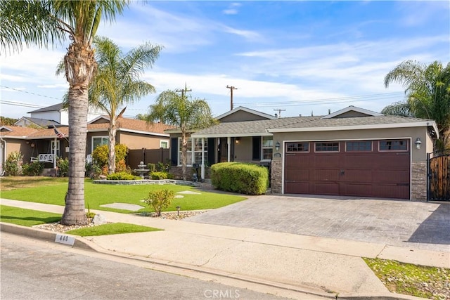 ranch-style house with a garage, decorative driveway, a front lawn, and stucco siding