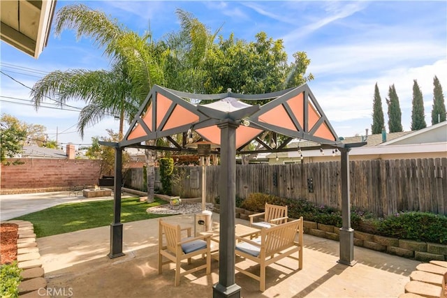 view of patio with a gazebo, outdoor dining space, and a fenced backyard