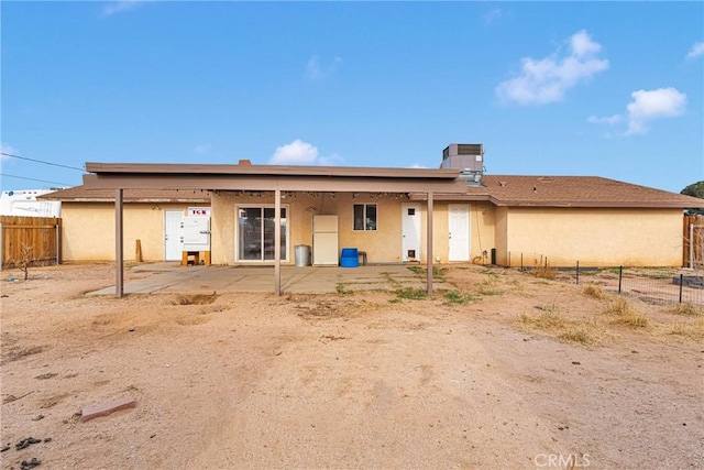 back of property featuring a patio area, fence, and stucco siding