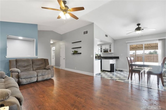 living room with a ceiling fan, lofted ceiling, visible vents, and wood finished floors