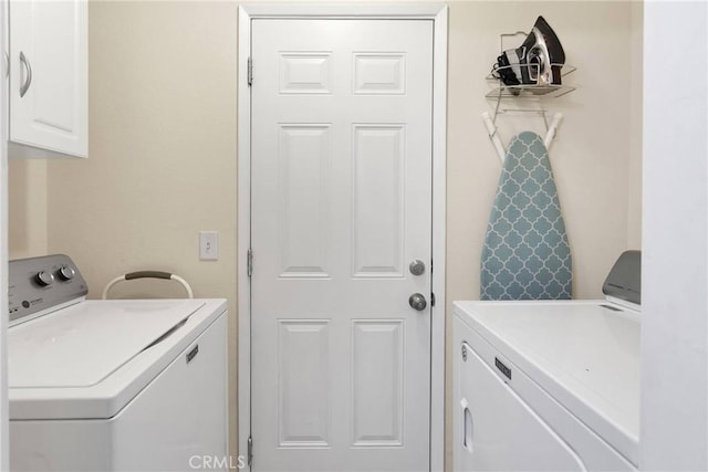 clothes washing area with cabinet space and washing machine and clothes dryer