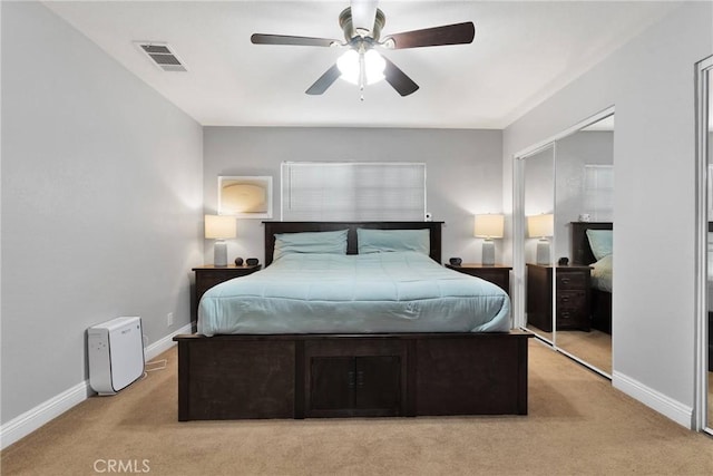 bedroom featuring light carpet, baseboards, visible vents, and a closet