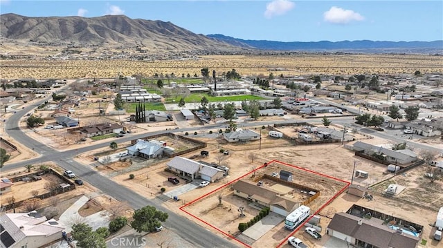 drone / aerial view featuring view of desert and a mountain view