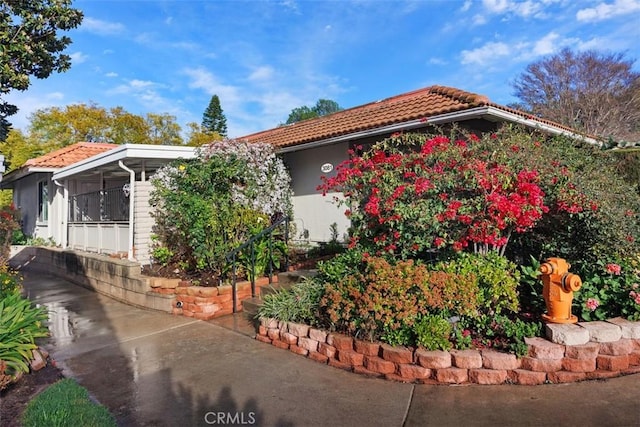 view of side of property with a tiled roof