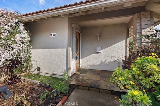 doorway to property with stucco siding