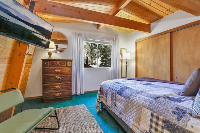 bedroom with a closet, carpet flooring, lofted ceiling with beams, and baseboards