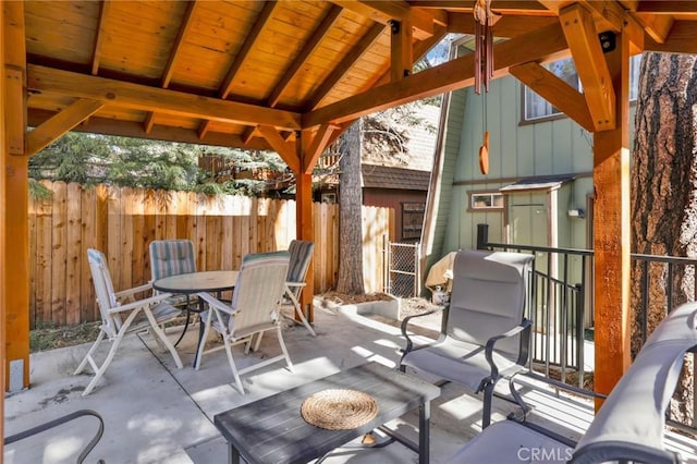 view of patio featuring a gazebo, fence, and outdoor dining space