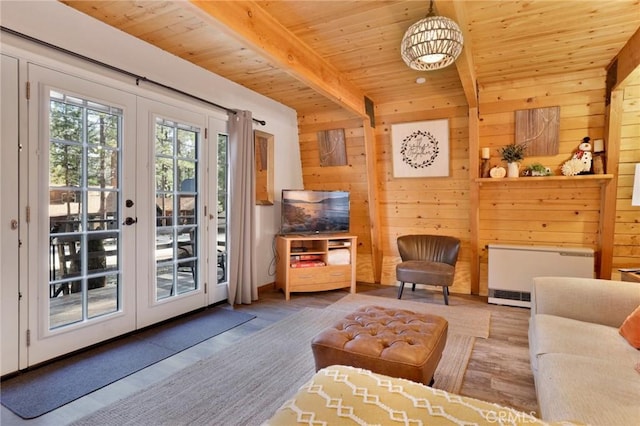 interior space with french doors, beam ceiling, radiator heating unit, wood finished floors, and wooden ceiling