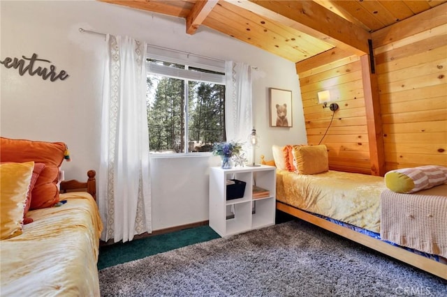 bedroom with lofted ceiling with beams, wooden ceiling, carpet flooring, and baseboards