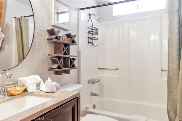 full bathroom featuring toilet, vanity, shower / bath combo with shower curtain, and a textured wall