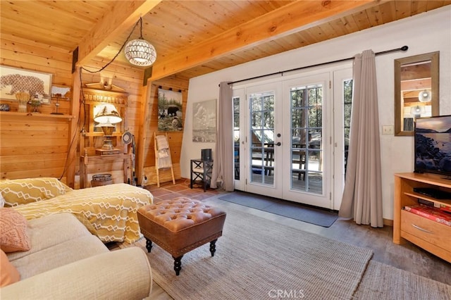 interior space featuring wooden ceiling, wooden walls, access to exterior, french doors, and beam ceiling