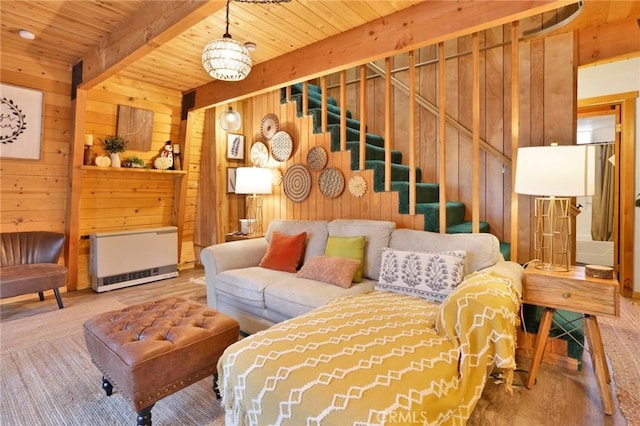 living area featuring wooden ceiling, wood finished floors, stairs, wood walls, and beam ceiling