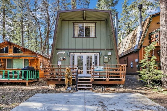 exterior space featuring a deck, french doors, and board and batten siding