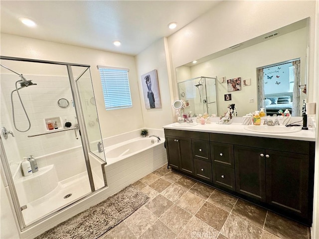 ensuite bathroom with double vanity, visible vents, ensuite bath, a shower stall, and a bath