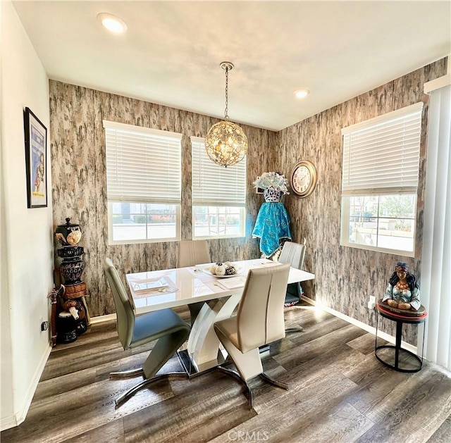 dining space with plenty of natural light, baseboards, and wood finished floors