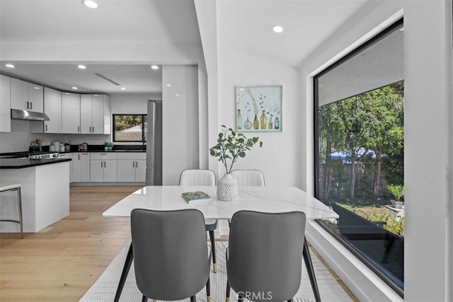 dining space with light wood-style floors and recessed lighting