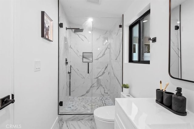 bathroom featuring a marble finish shower, baseboards, toilet, marble finish floor, and vanity