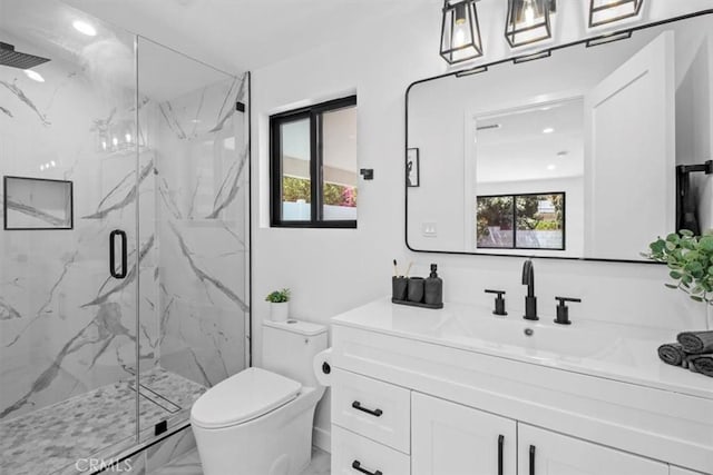 full bath with marble finish floor, vanity, a marble finish shower, and toilet