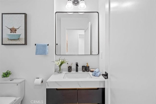 half bath with vanity and toilet