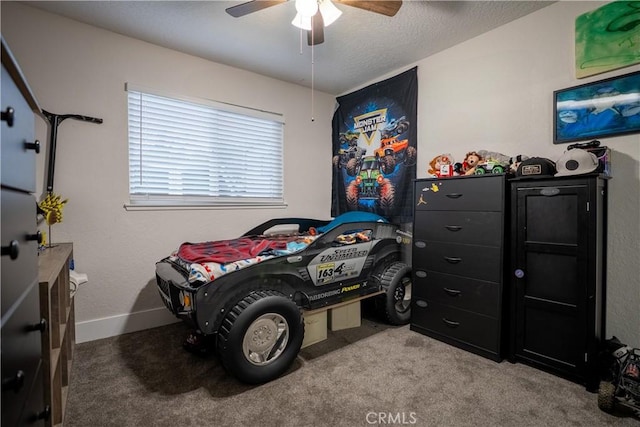 carpeted bedroom with ceiling fan and baseboards