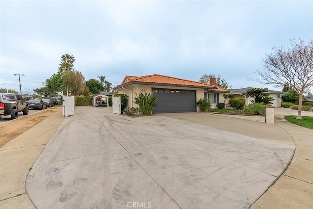 view of street featuring concrete driveway and a gate