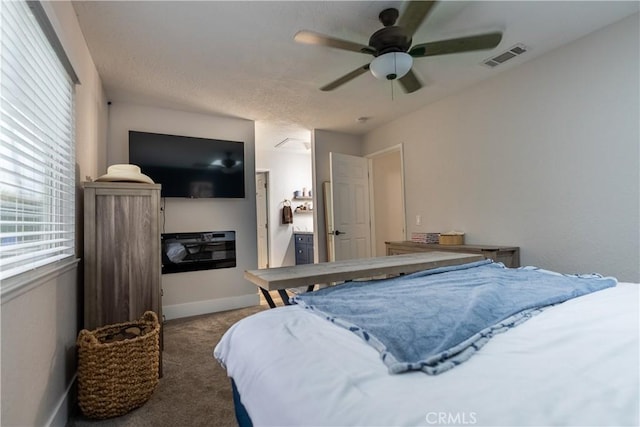 carpeted bedroom with a ceiling fan, visible vents, and baseboards