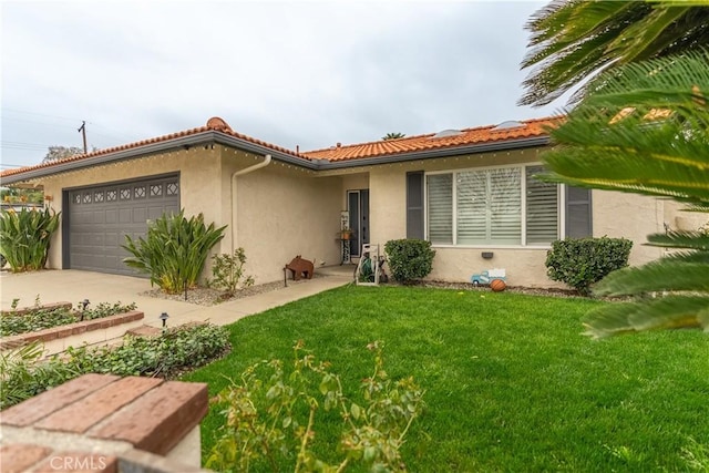 view of front facade with an attached garage, a tiled roof, a front lawn, and stucco siding