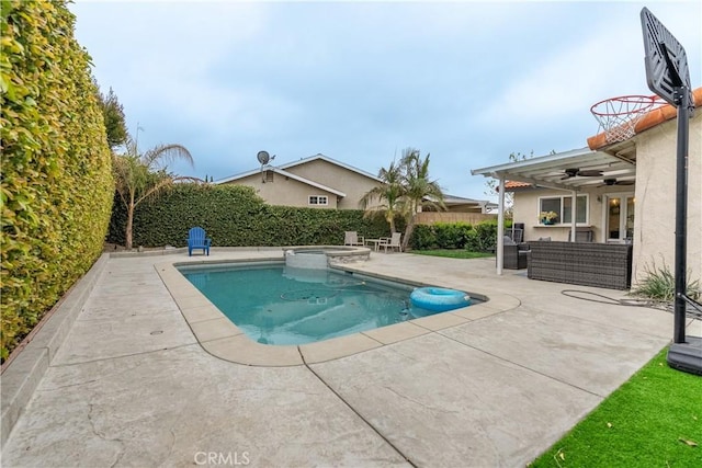 view of swimming pool with a patio, a pool with connected hot tub, outdoor lounge area, a ceiling fan, and fence