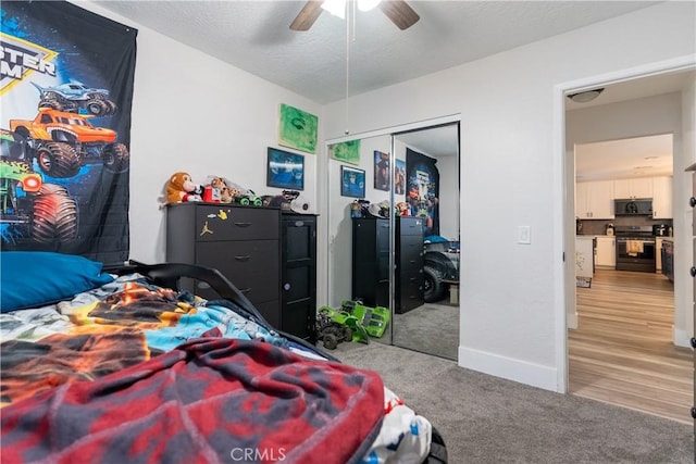 bedroom with ceiling fan, a closet, carpet, and baseboards