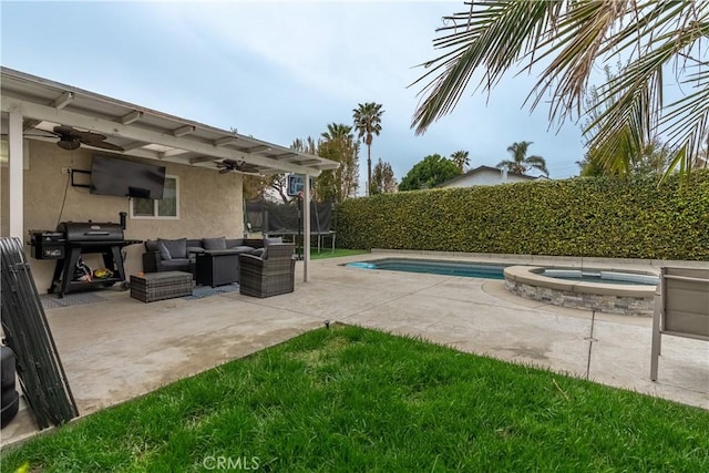 view of patio / terrace with a ceiling fan, area for grilling, an outdoor hangout area, a trampoline, and a pool with connected hot tub