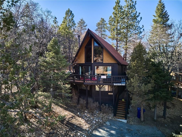 back of house with a deck and stairs