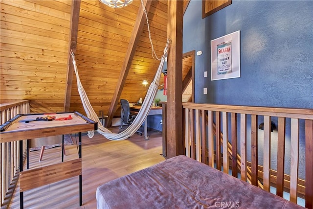 rec room with vaulted ceiling with beams, a textured wall, wood finished floors, and wood ceiling