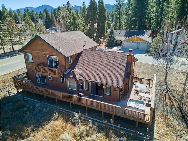 birds eye view of property with a mountain view and a forest view