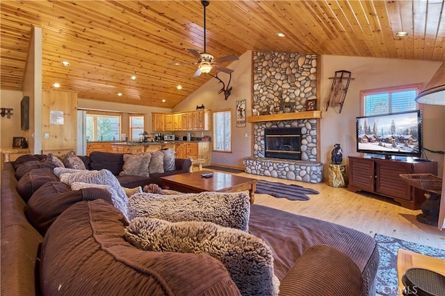 living area with a healthy amount of sunlight, light wood-type flooring, a fireplace, and wood ceiling